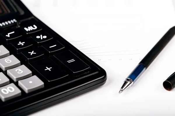 Business Charts with calculator and pen — Stock Photo, Image