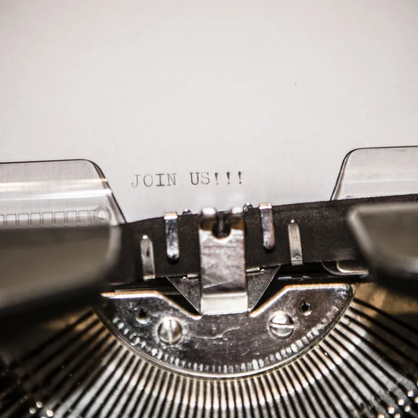 Old typewriter with text join us — Stock Photo, Image