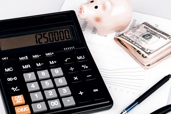 Business Charts with calculator, money, piggy box and pen — Stock Photo, Image