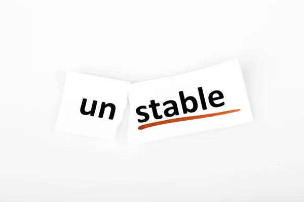 La palabra inestable cambió a estable en papel roto — Foto de Stock