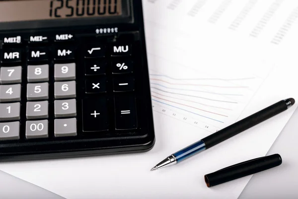 Business Charts with calculator and pen — Stock Photo, Image