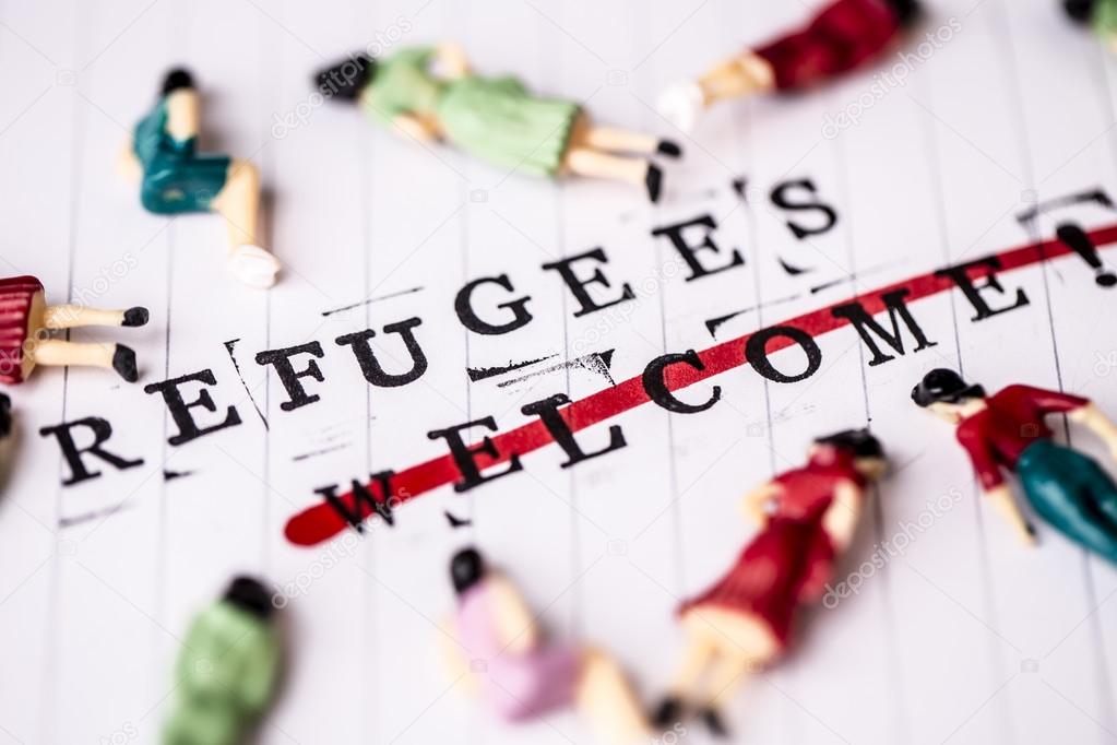 refugees welcome strikethrough text on paper