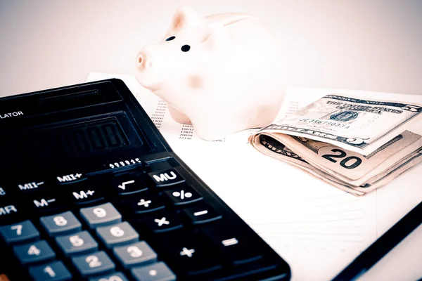 Business Charts with calculator, money, piggy box and pen — Stock Photo, Image