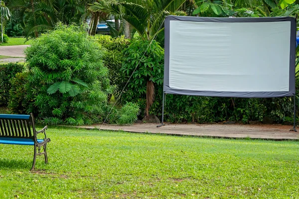 Outdoor movie screen in a tropical tourist caravan park for guest viewing
