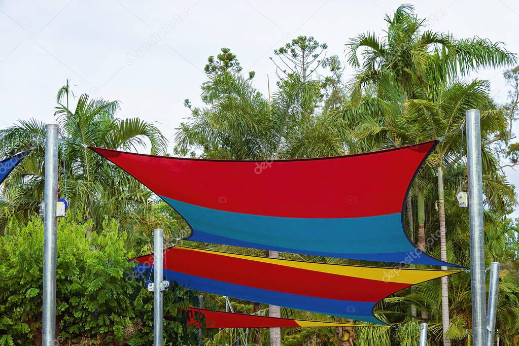 Colourful sails covering a children's playground to provide shade and keep the sun away