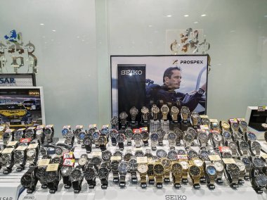 Mackay, Queensland, Avustralya - Şubat 2021: Bir alışveriş merkezi vitrininde afiş reklamlarıyla birlikte satılık erkek saatleri sergisi