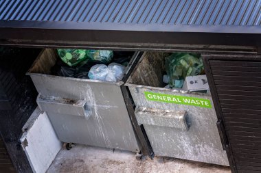 Airlie Beach, Queensland, Avustralya - Nisan 2021: Çöp ve genel çöp bidonları barakada depolandı