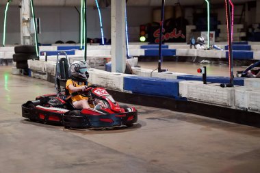 Mackay, Queensland, Australia - April 2021: A young girl drives a go-kart in a fun recreational drive around a circuit in public