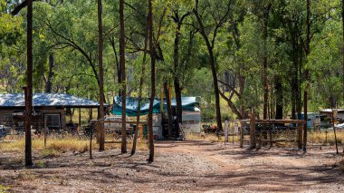 Rubyvale, Queensland, Avustralya - Mayıs 2021: Mücevher arama sahalarında araçlar ve çöplerle dolu bir bahçede bir taş ev inşa edildi