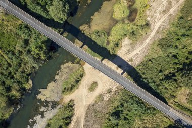 High aerial landscape of a highway bridge over a country creek, interesting pattern