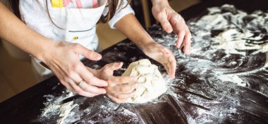 Anne ve kızı mutfakta yemek pişiriyor.