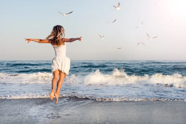 Mooi meisje springen op zee — Stockfoto