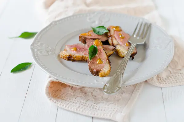 Roasted duck breast on a plate with sea buckthorn sauce — Stock Photo, Image