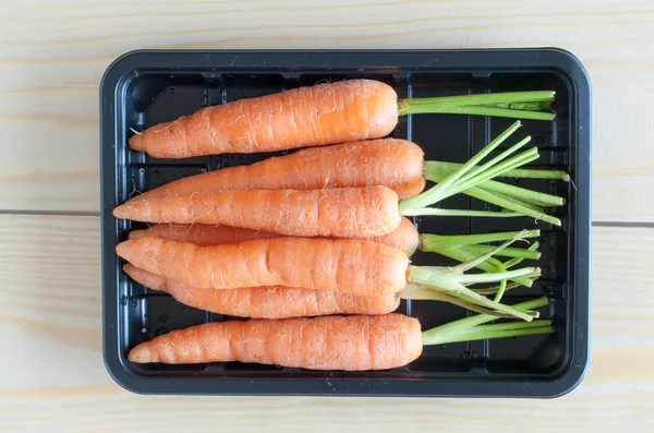Baby carrots in a black container
