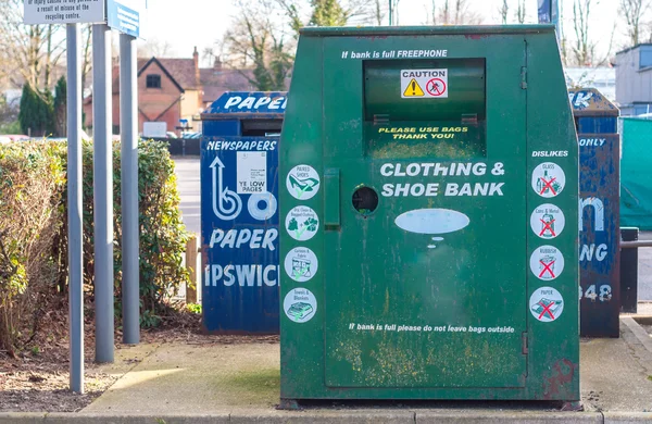 A collection bin for second hand clothes and shoes in a carpark — Stock Photo, Image