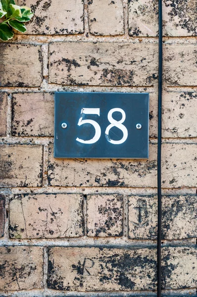 House number fifty eight for use as a background — Stock Photo, Image