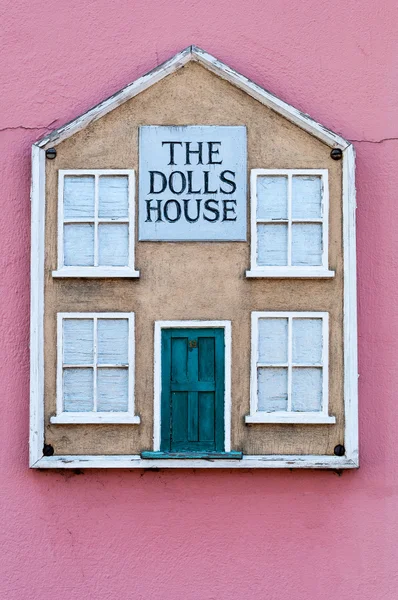 De poppen teken buiten een terracotta cottage muur huis Rechtenvrije Stockfoto's