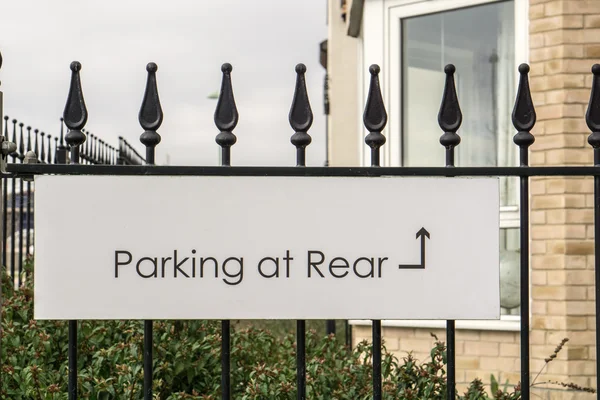 Sign for 'Parking at Rear' on a metal fence — Stock Photo, Image