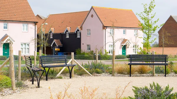 Park benches outside a modern housing development — Stock Photo, Image