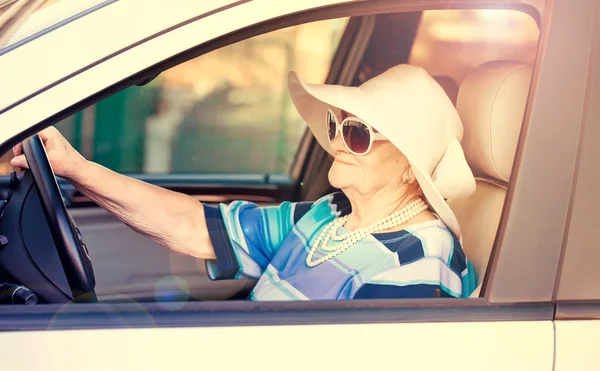 Mature woman driving automobile Stock Image