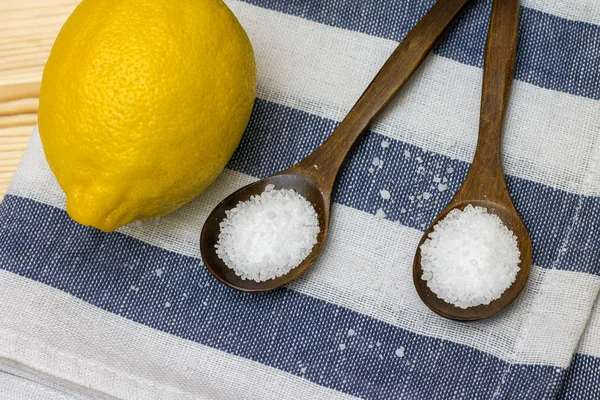 Wooden spoon with citric acid on striped tablecloth — Stock Photo, Image