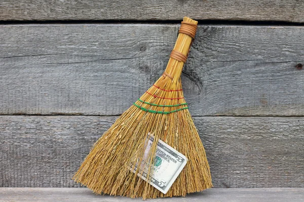 Concept of mismanagement. Broom stuck with dollars — Stock Photo, Image