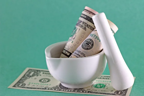 Financial concept - money in mortar with pestle — Stock Photo, Image