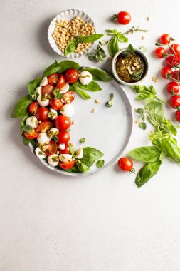 Klasik İtalyan caprese salatası taze domatesli, mozzarella, fesleğen, çam fıstığı, pesto ve taze kekik soslu..