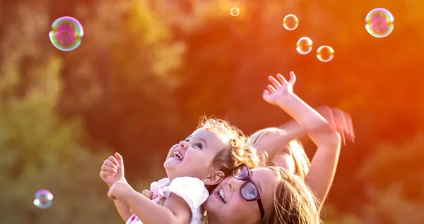 Girls having fun soap bubbles — Stock Photo, Image