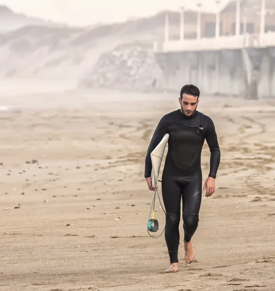 Surfer going out of the water — Stock Photo, Image