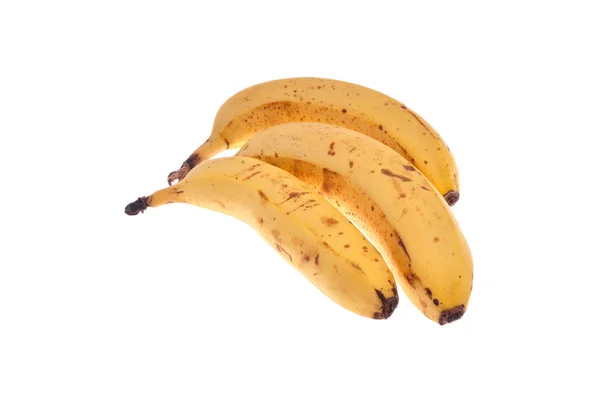 Trzy w ciągu dojrzałe banany na białym tle — Zdjęcie stockowe