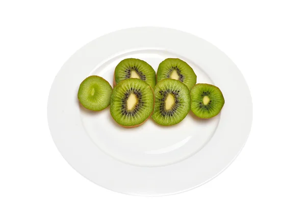 Kiwi fruit slices on white plate, isolated on white background. — Stock Photo, Image