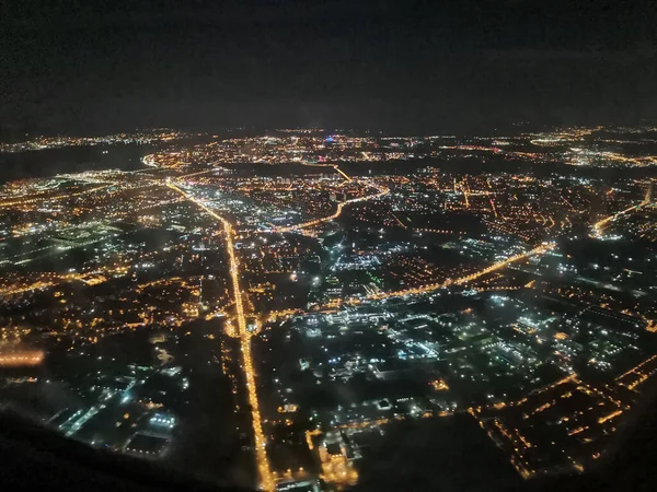 Le luci di Big City dal finestrino dell'aereo di notte. Nizhny Novgorod, Russia — Foto Stock