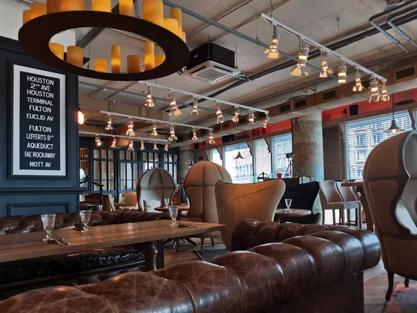 interior of a luxury, expensive restaurant with leather sofas, wooden tables, capsule chairs. Modern design