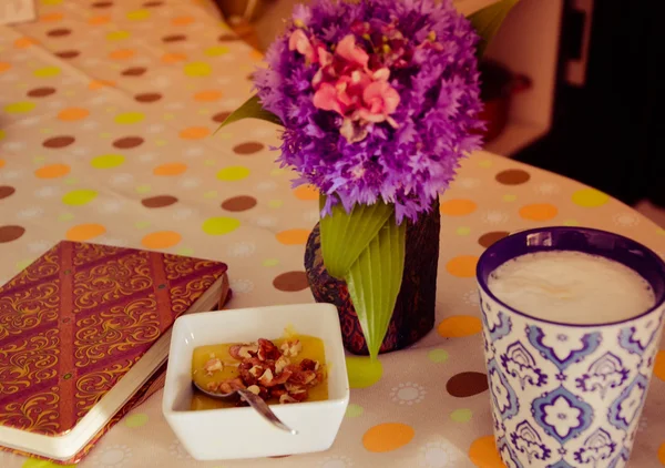 Cup of hot coffee, flowers and book. Romantic background with retro filter effect — Stock Photo, Image