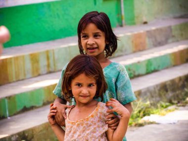 Rural smiling girls sisters closeup morning in sunlight India
