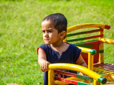 handsome Indian kid having funat a local park
