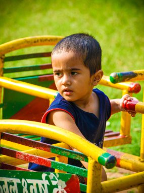 handsome Indian kid having funat a local park