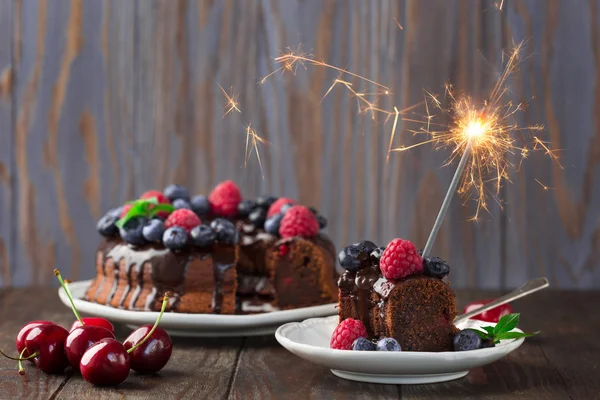 Chocolate berry cake with a sparkler — Stock Photo, Image