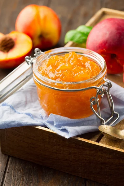 Jar of peach jam with fresh fruits — Stock Photo, Image