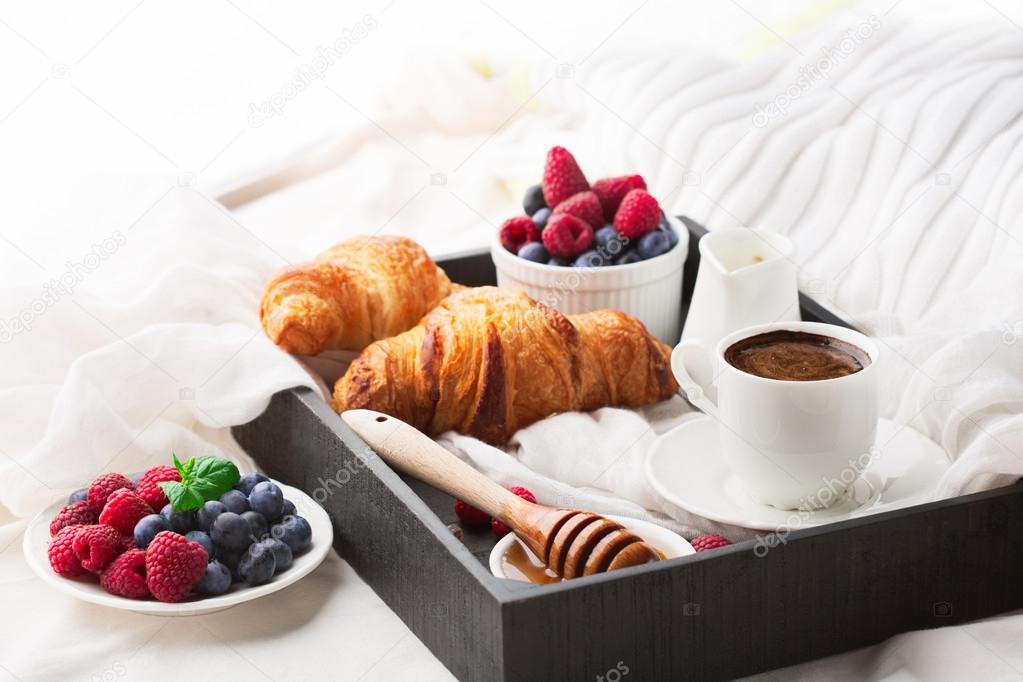 Breakfast in bed with cup coffee 