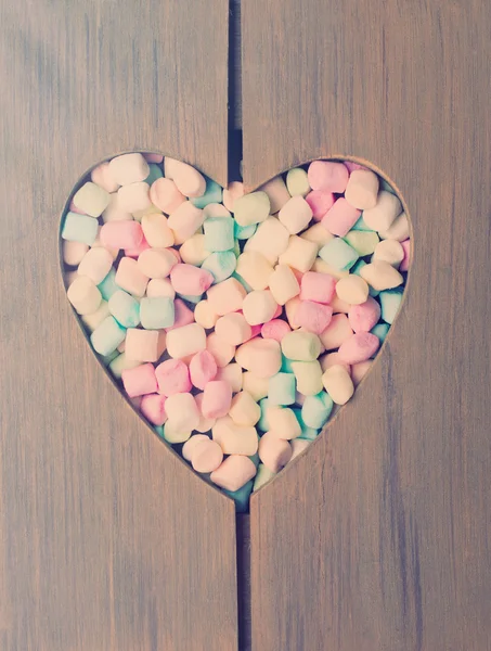 Small Marshmallows in Wooden heart frame.