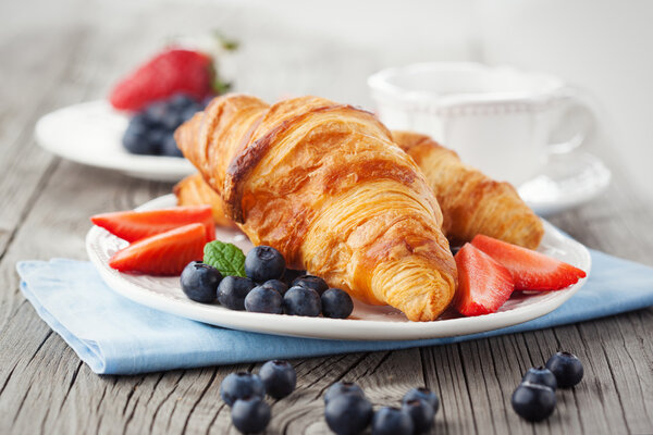 Fresh croissants and ripe berries