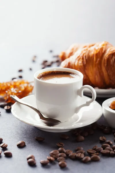 Fresh croissants  and cup of coffee on a table — Stock Photo, Image