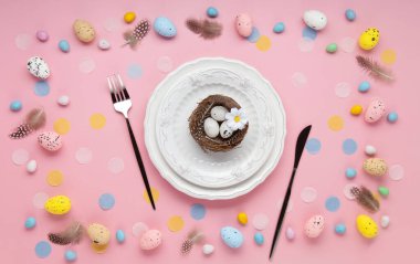 Paskalya bayramı kartı. Neşeli tavşan, boyanmış yumurta, bahar çiçekleri, açık pembe arka planda dekoratif elementler.