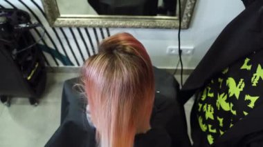 Kuaför kuaför kuaförde saç kurutma makinesiyle kadın saçı tutuyor. Yukarıdan görüntüle