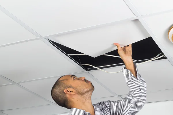 Asian man install suspended ceiling — Stock Photo, Image