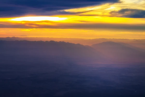 Blue mountain with orange sky while rising sun — Stock Photo, Image