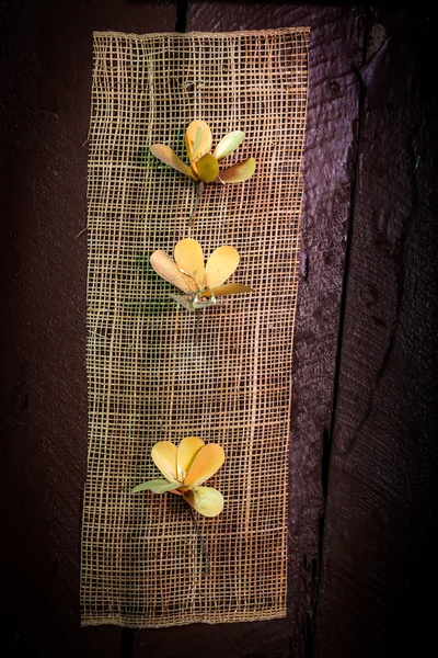 Artificial flower hang on brown wooden wall — Stock Photo, Image