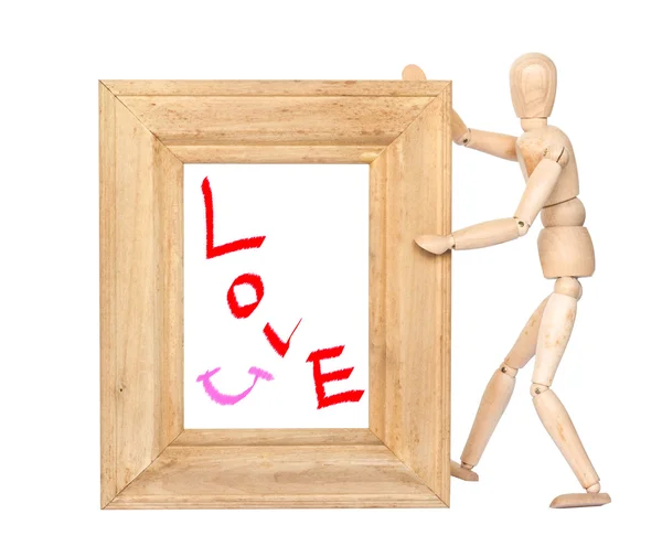 Houten figuur houden vierkante houten frame met liefde en glimlach insid — Stockfoto